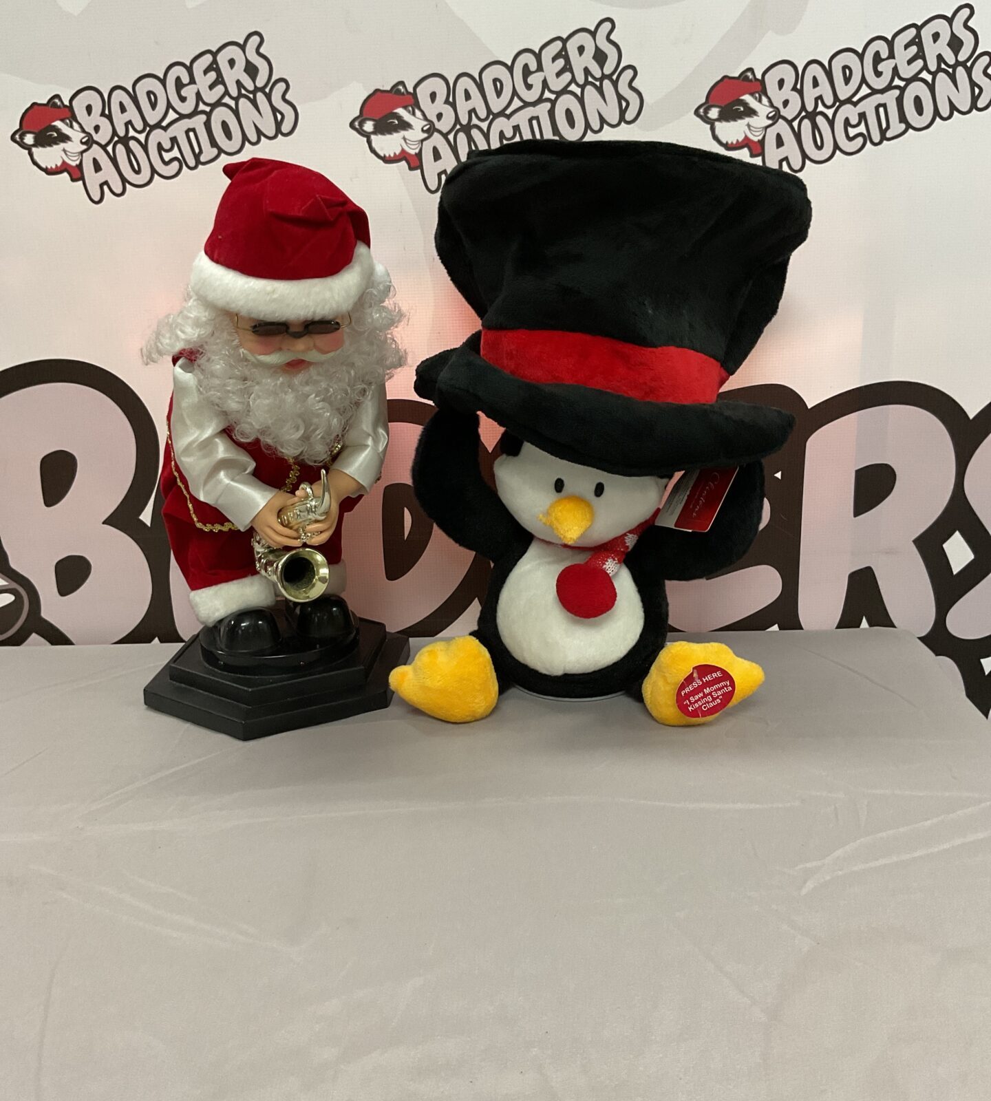 Singing Santa and Clinton penguin Christmas decorations, festive holiday decor.