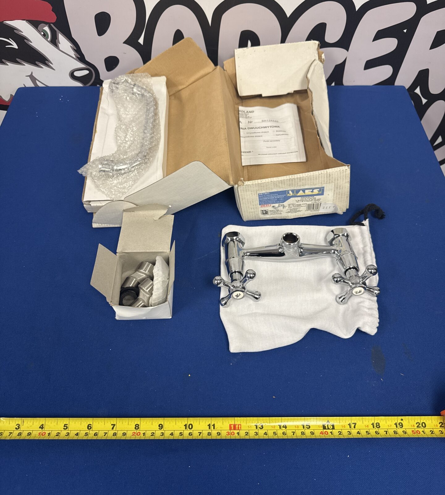 New chrome basin mixer tap in original packaging.
