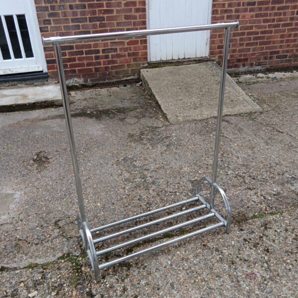 Vintage chrome clothes rail for displaying garments.