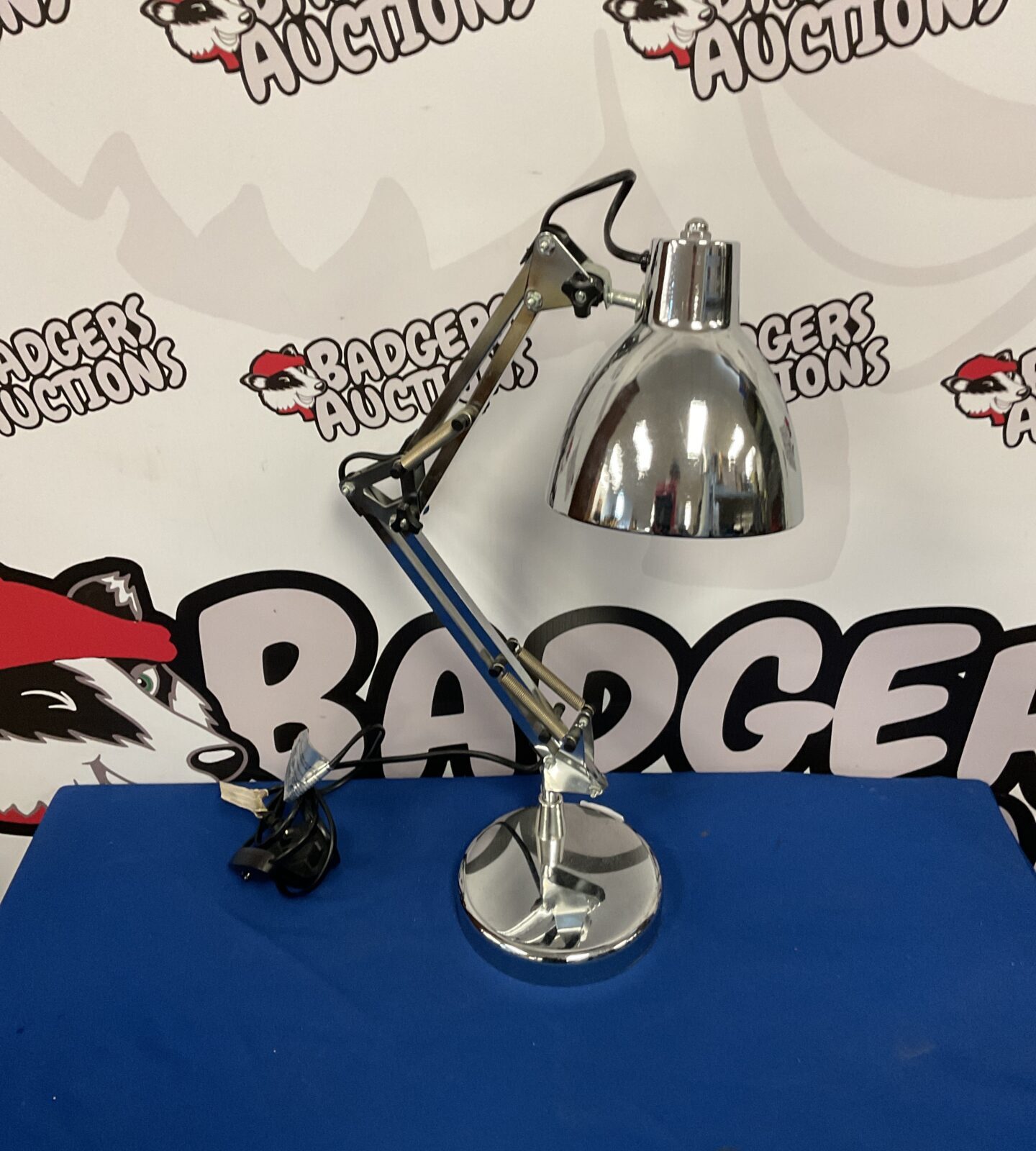 Adjustable chrome table lamp with a classic mid-century modern design.