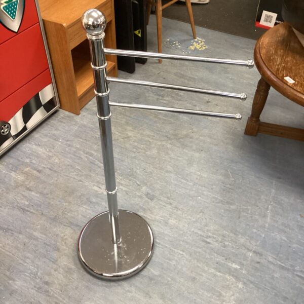 Chrome freestanding towel hanger for bathroom storage.