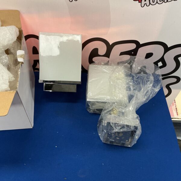 Pair of chrome wall lights with shades for home decor.