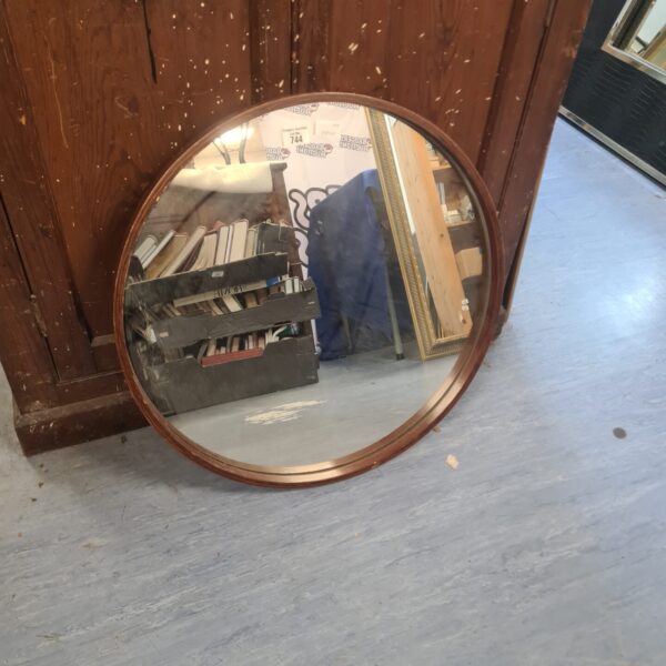 Vintage circular framed mirror with wooden frame.