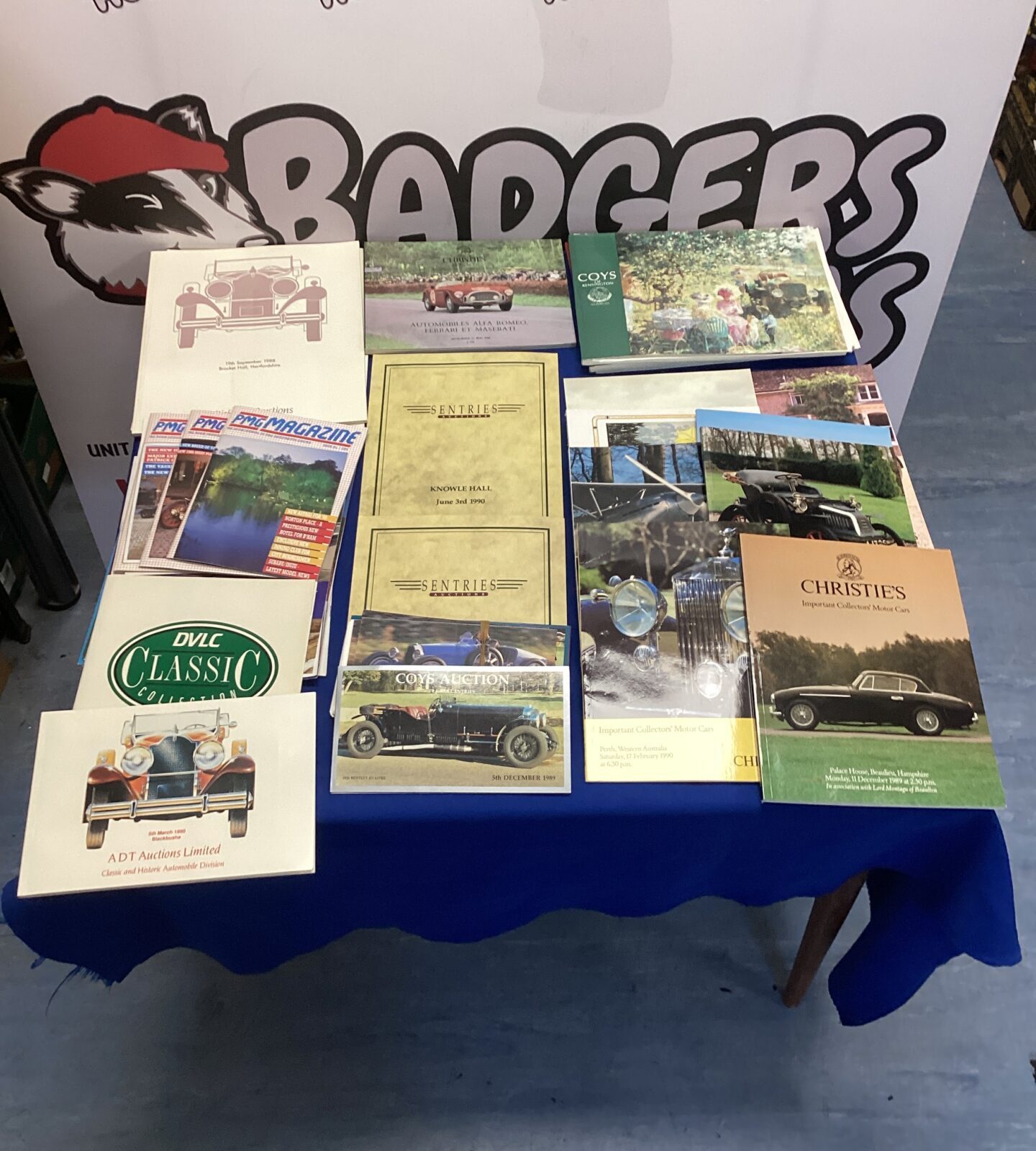 Stack of classic car auction price guides and catalogues.