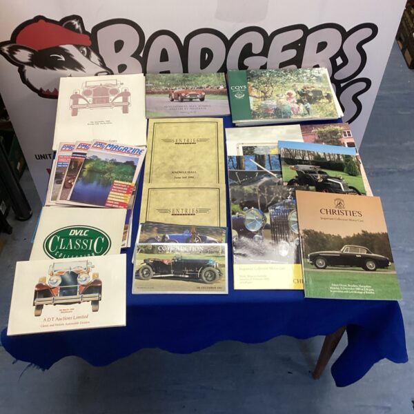 Stack of classic car auction price guides and catalogues.