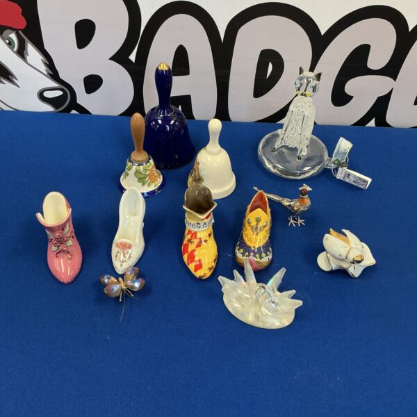 Close-up of Coalport collectible boots and decorative porcelain items.