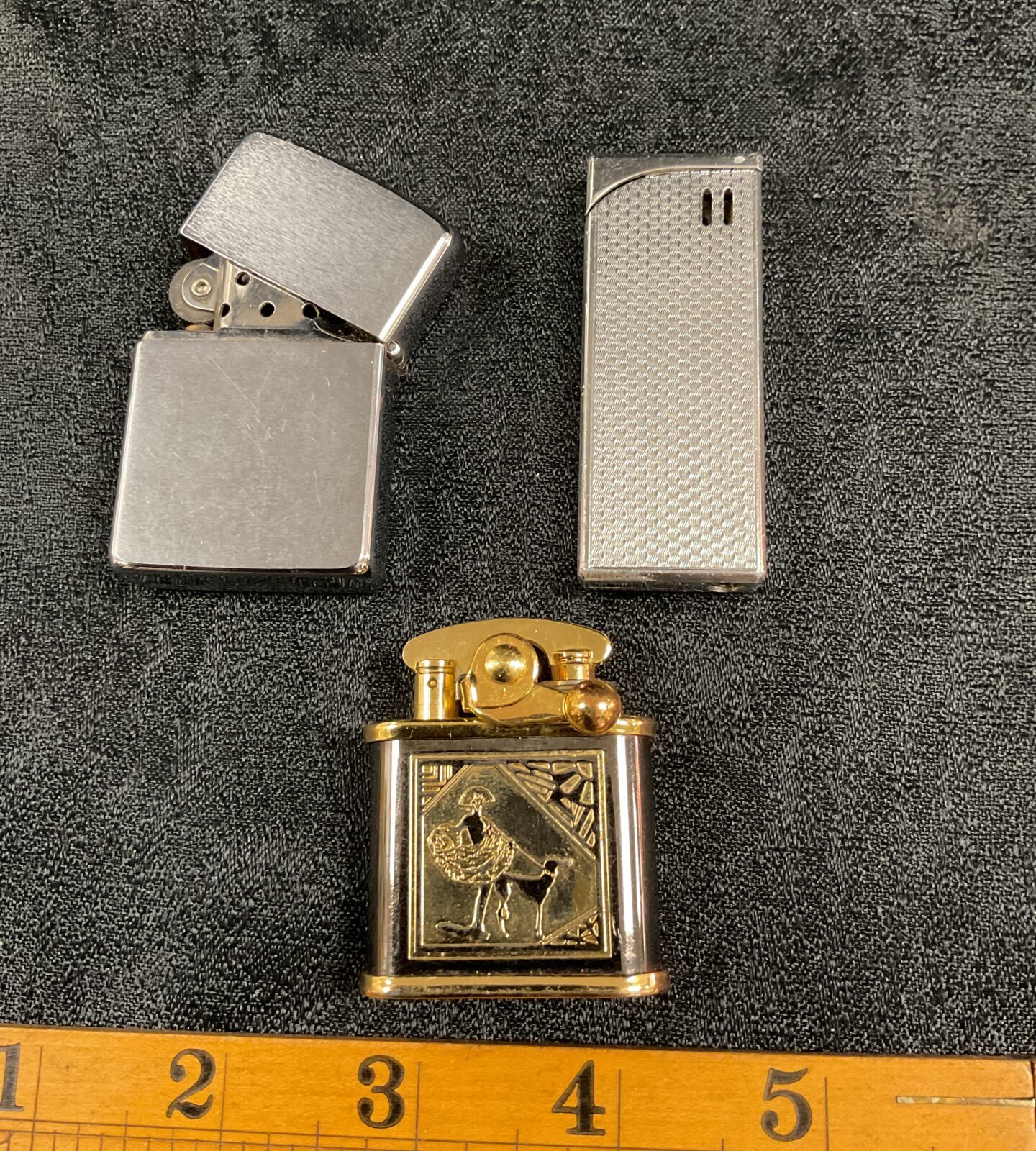 Close-up of the Colibri centenary year lighter with gold engraving.
