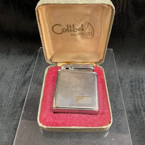 Vintage Colibri gas lighter in original protective case.