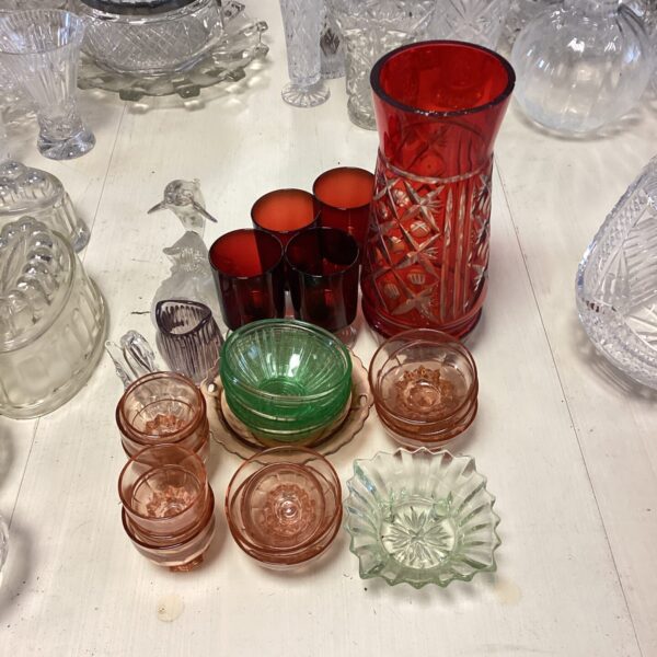 Vintage coloured glass collection featuring cranberry glasses and a vase.