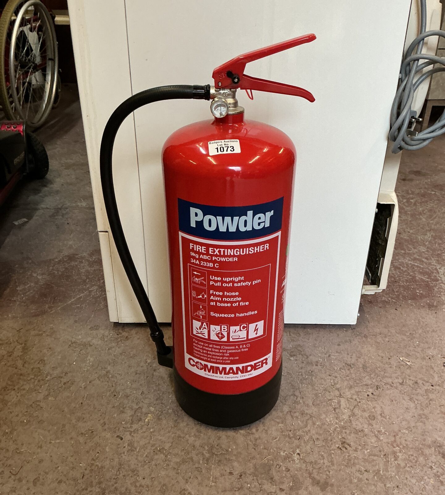 Red vintage Commander powder fire extinguisher for collectors.