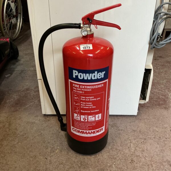 Red vintage Commander powder fire extinguisher for collectors.