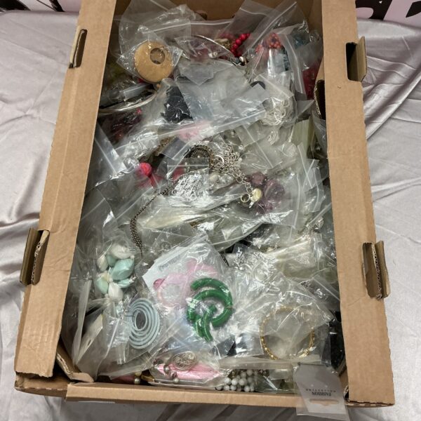 Large lot of colourful costume jewellery in a cardboard box.