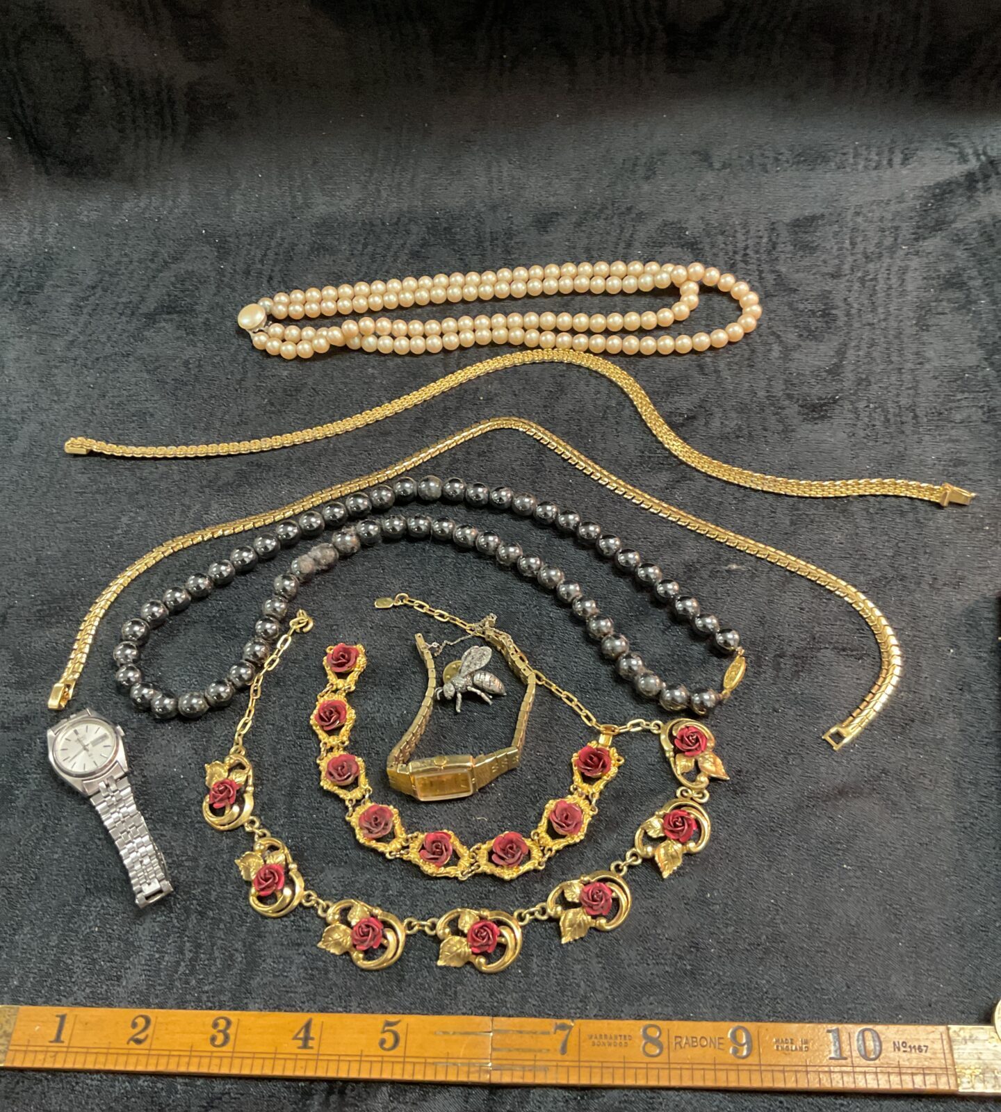 Assorted vintage costume jewellery tray with necklaces and brooches.