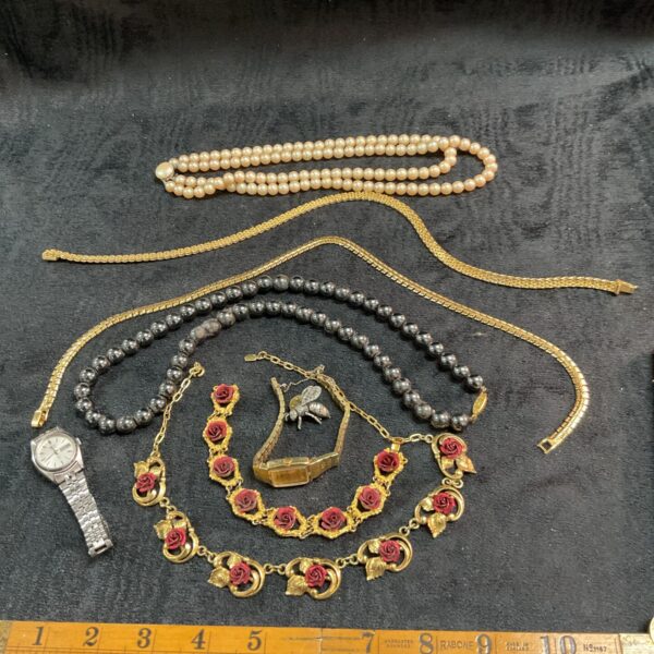 Assorted vintage costume jewellery tray with necklaces and brooches.