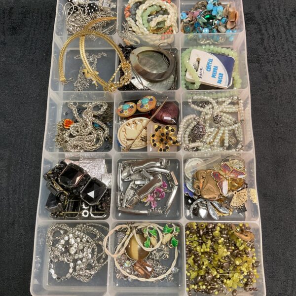 Tray of mixed costume jewellery with necklaces, earrings, and brooches.