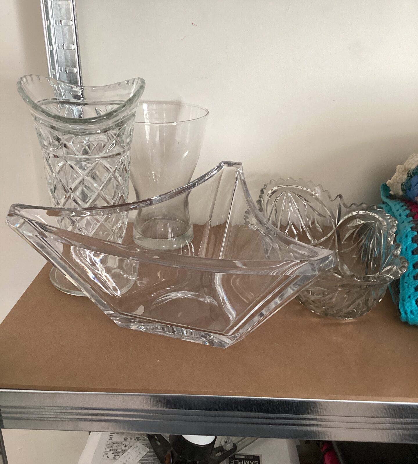 Vintage crystal glass vases and bowls on display.