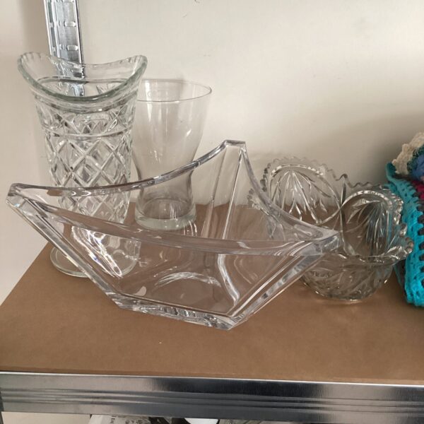 Vintage crystal glass vases and bowls on display.