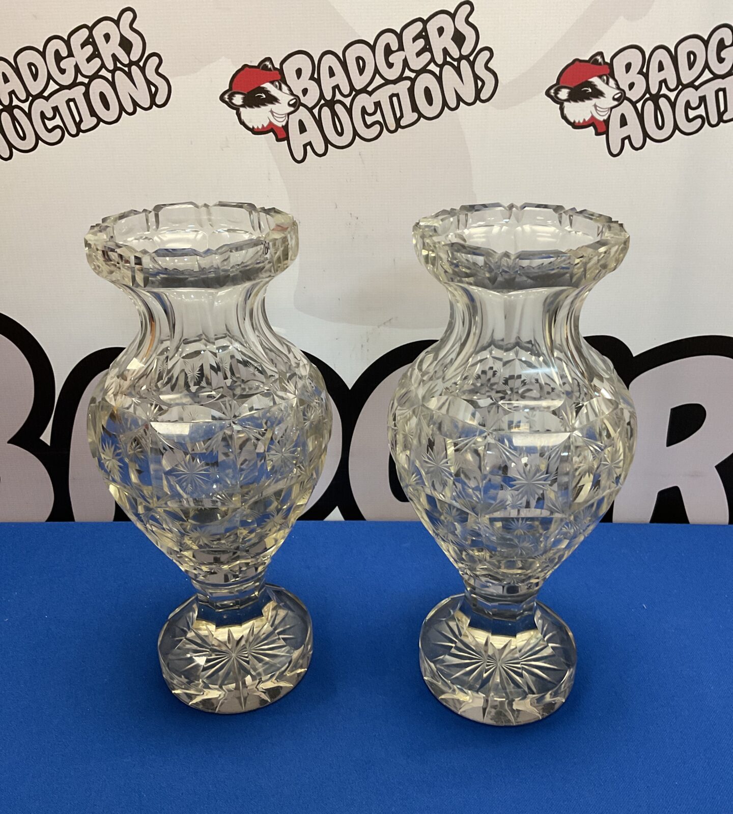 Pair of vintage crystal glass vases on a white background.