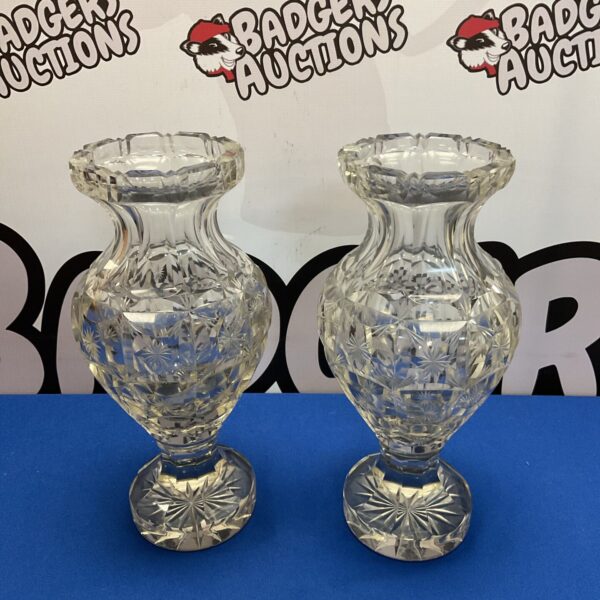 Pair of vintage crystal glass vases on a white background.
