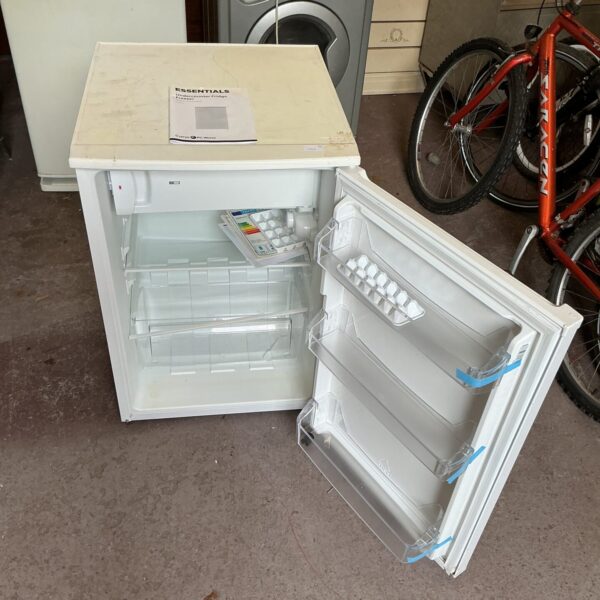 White Curry’s Essentials compact fridge in a garage setting.