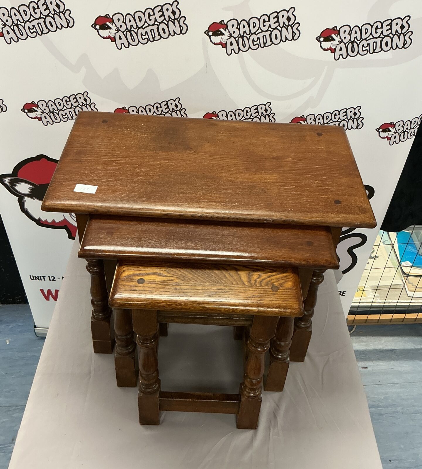 Vintage dark oak nest of tables in graduated sizes.