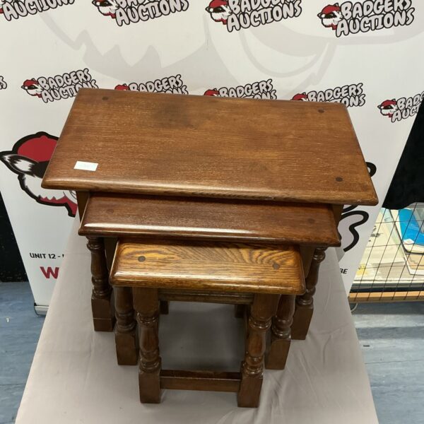 Vintage dark oak nest of tables in graduated sizes.