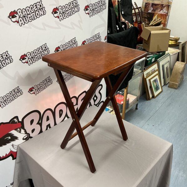 Vintage dark wood folding side table in good condition.