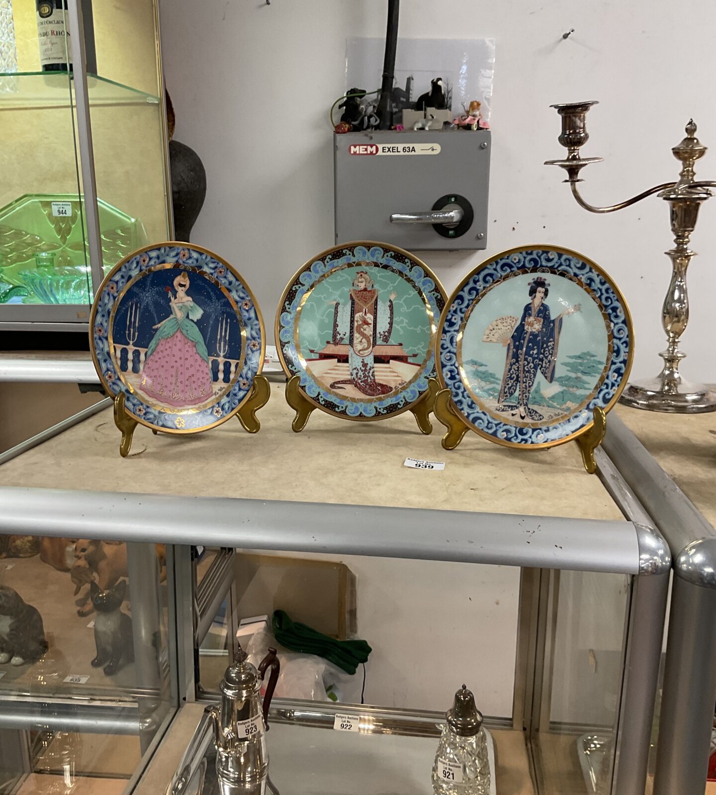 Set of three antique De Wan porcelain plates with detailed paintings.