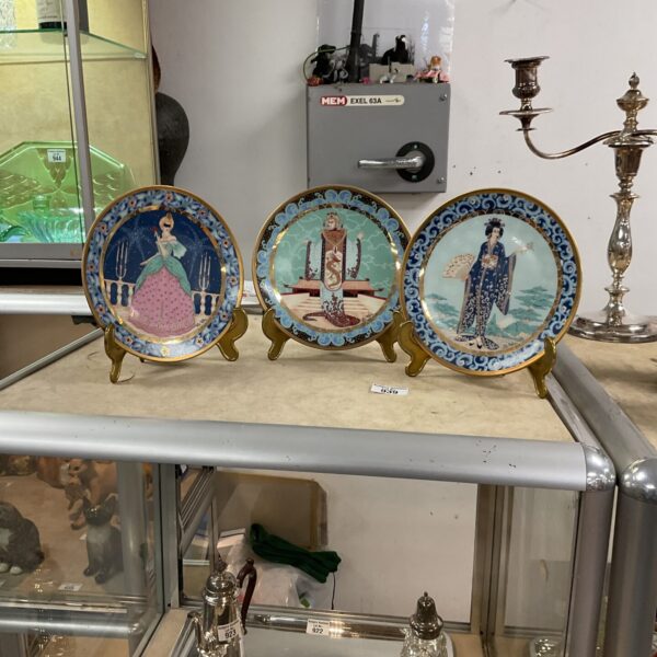 Set of three antique De Wan porcelain plates with detailed paintings.