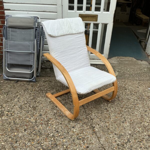 White upholstered designer easy chair with wooden frame.