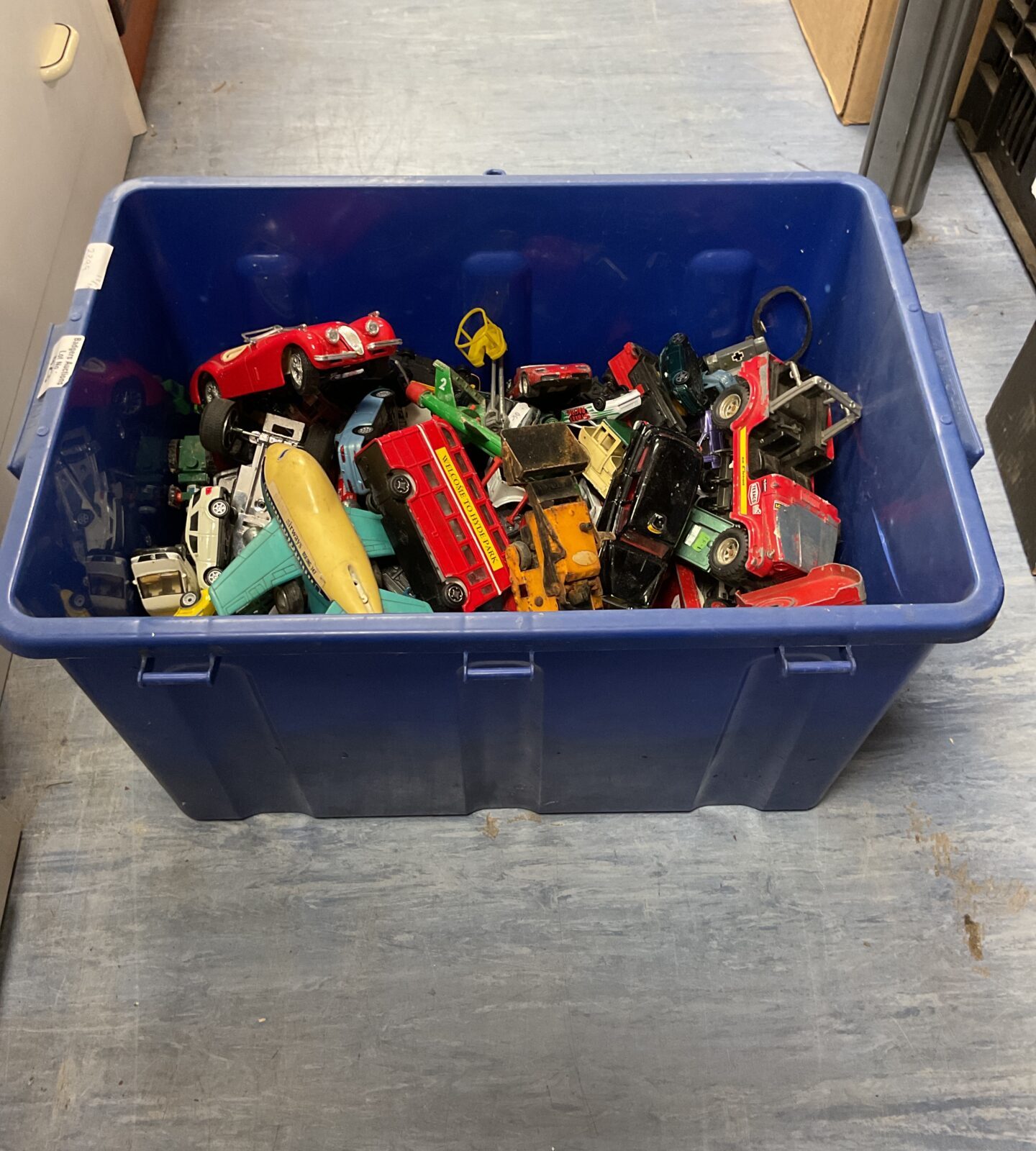 Blue box filled with a large lot of diecast model cars.