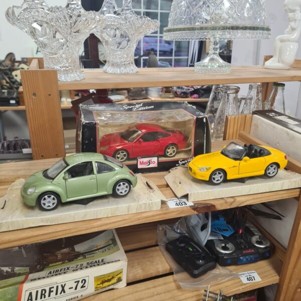 Diecast model cars including a Maisto Honda S2000 for collectors.