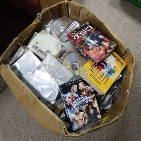 Mixed lot of DVDs and CDs for home entertainment.