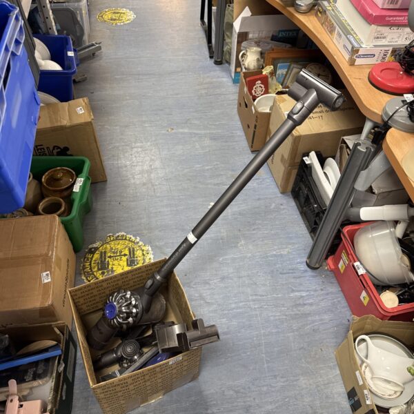 Dyson V6 Animal Extra cordless vacuum cleaner with accessories.