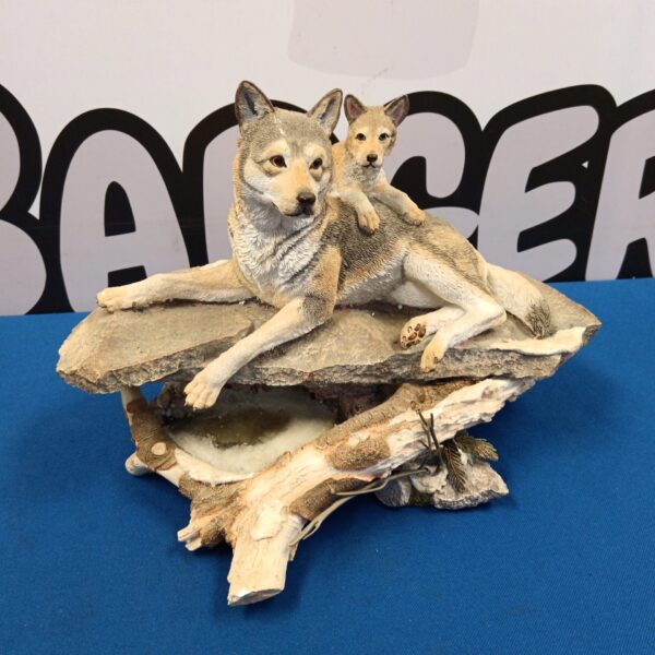 Detailed resin wolf sculpture of father and cub titled "Early Thaw".