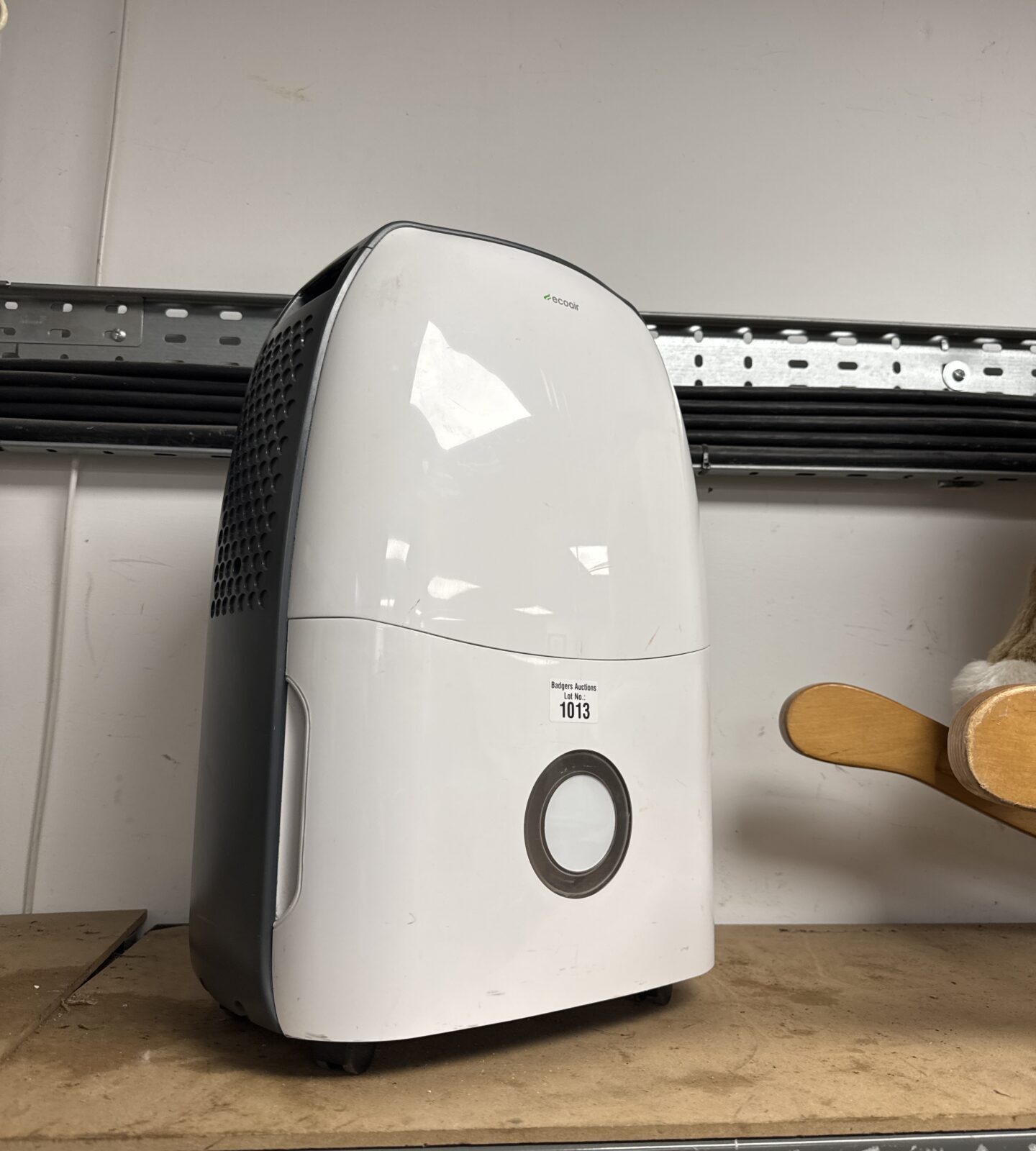 White Ecoair portable dehumidifier unit on a shelf.