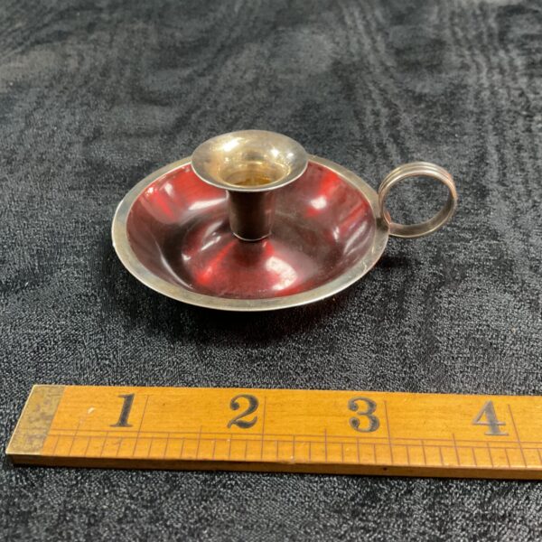 Antique Einar Dragsted silver candle stick with red interior.