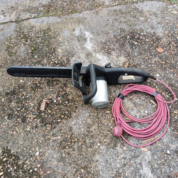 Unbranded electric chainsaw with power cord, used condition.