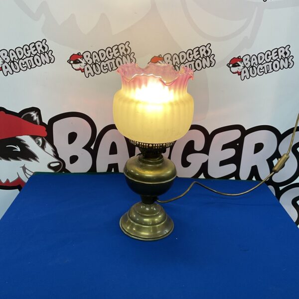 Vintage electric oil lamp with frosted glass shade.