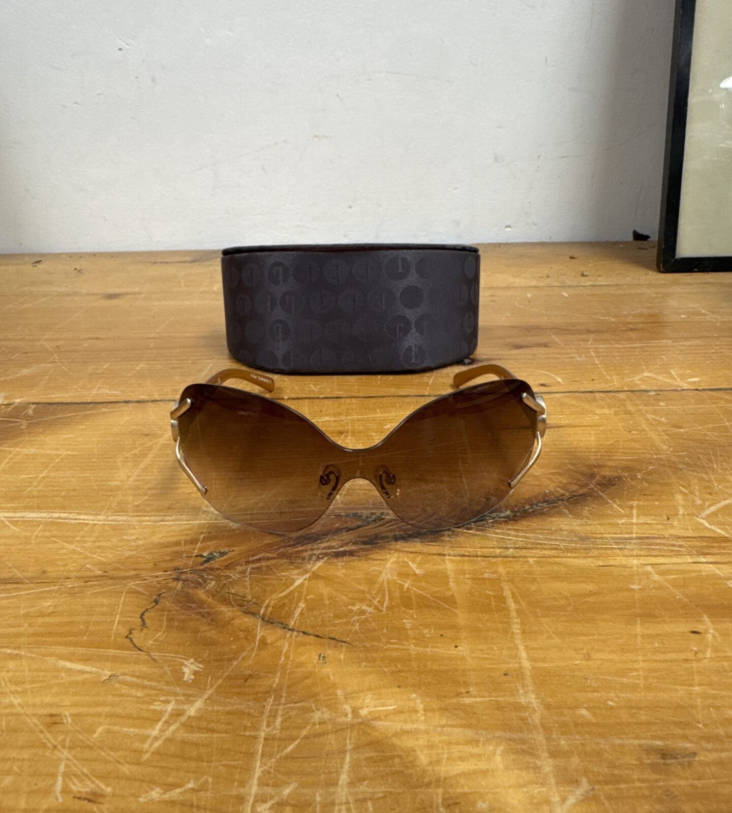 Vintage Elle sunglasses with amber lens and gold frame.