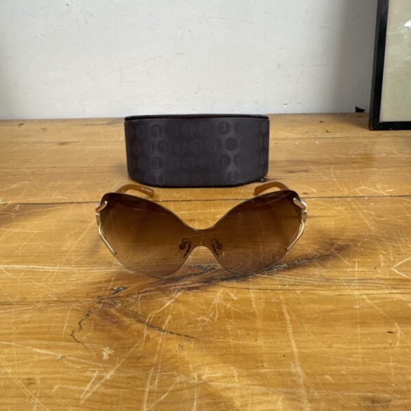 Vintage Elle sunglasses with amber lens and gold frame.
