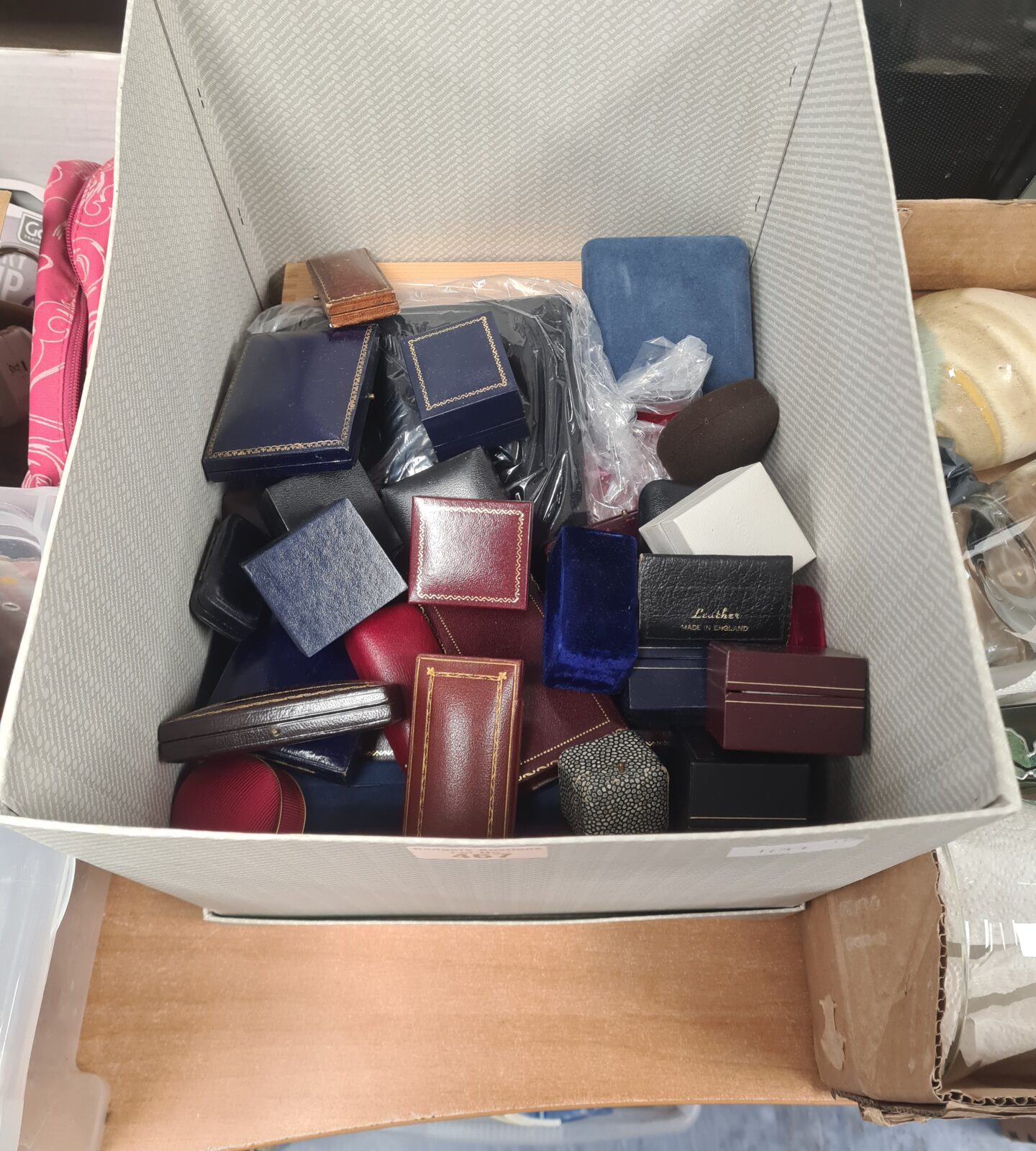 Mixed lot of empty jewellery boxes in blue, red, and brown.
