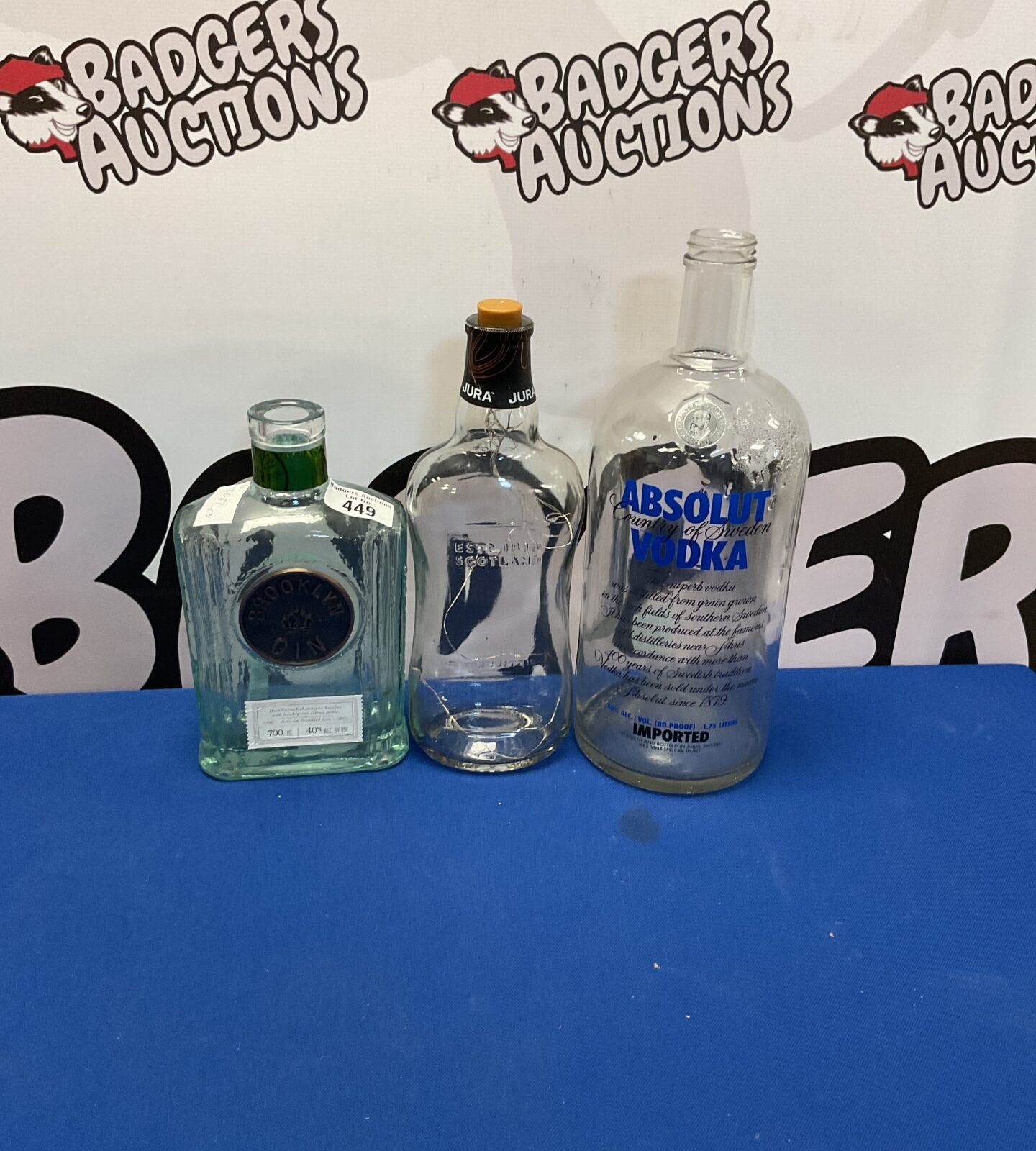 Lot of empty liquor bottles including Absolut Vodka and Brooklyn Gin.