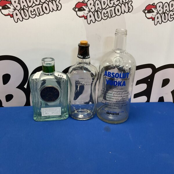 Lot of empty liquor bottles including Absolut Vodka and Brooklyn Gin.