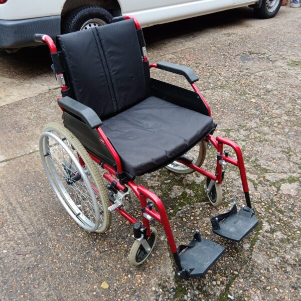 Red Enigma large wheelchair, side view, mobility aid.