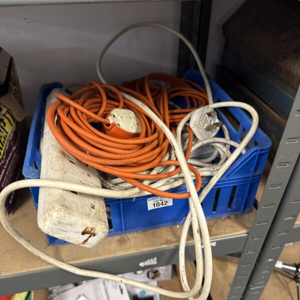 Assorted orange extension leads in a tray, electrical cable lot.