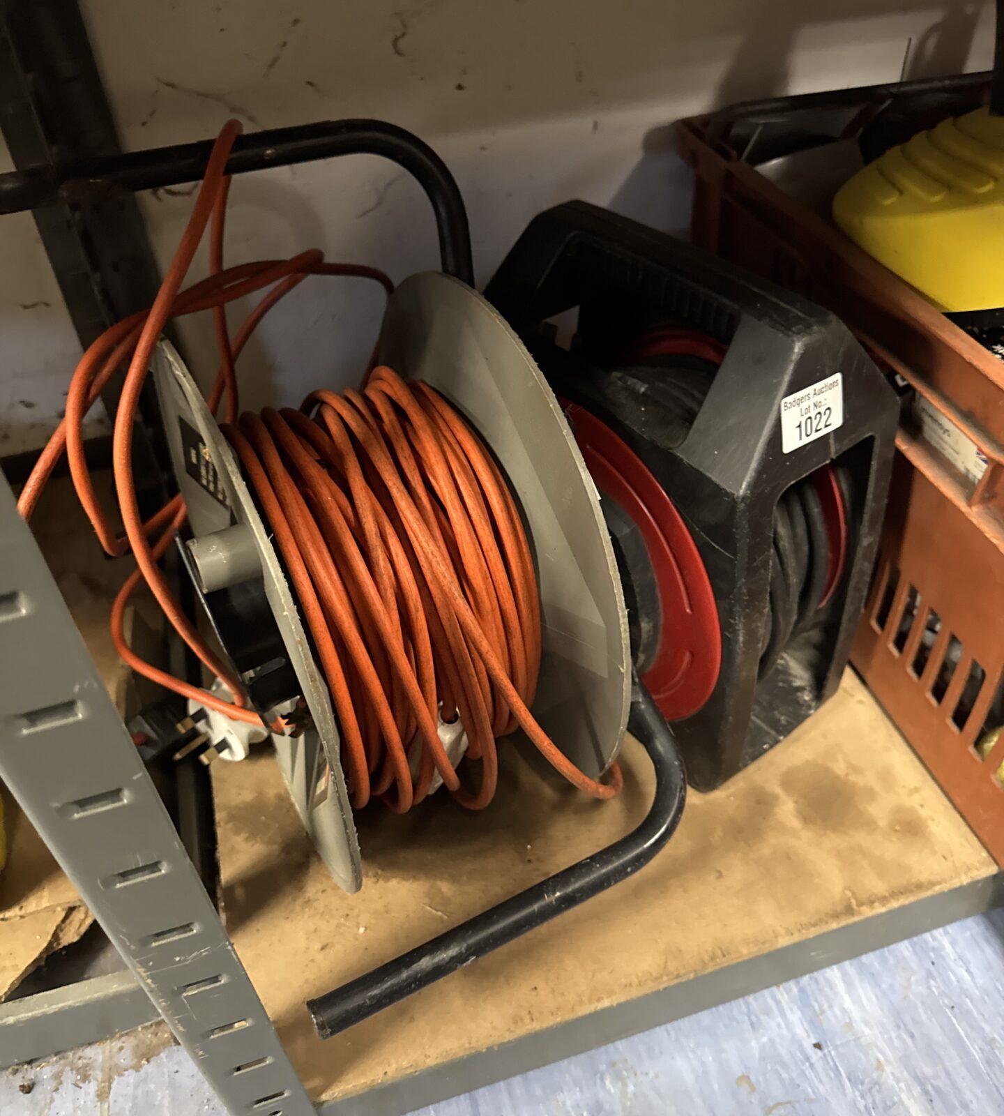 Used extension reel with orange cable for garden or workshop use.