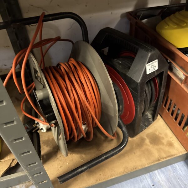 Used extension reel with orange cable for garden or workshop use.