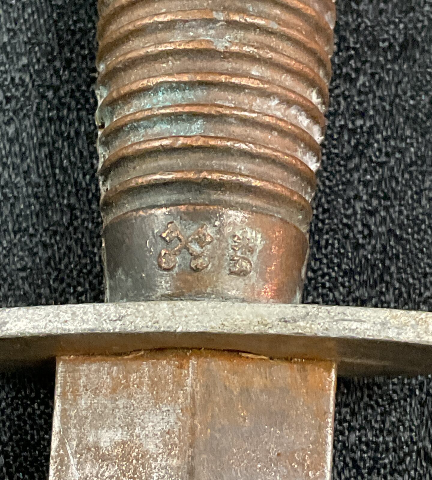 Close-up of Fairbairn Sykes Commando dagger blade showing damage and wear.