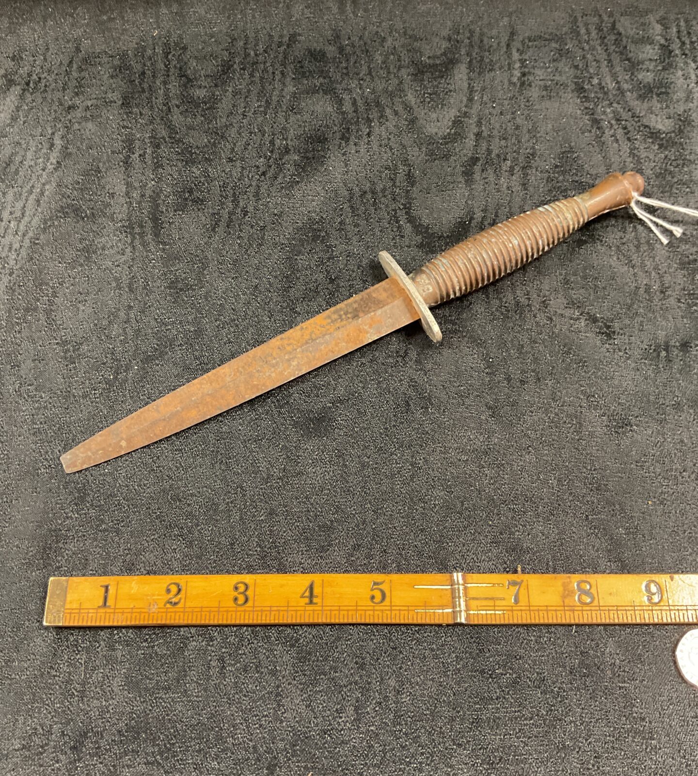 Vintage Fairbairn Sykes Commando dagger with textured grip and leaf-shaped blade.